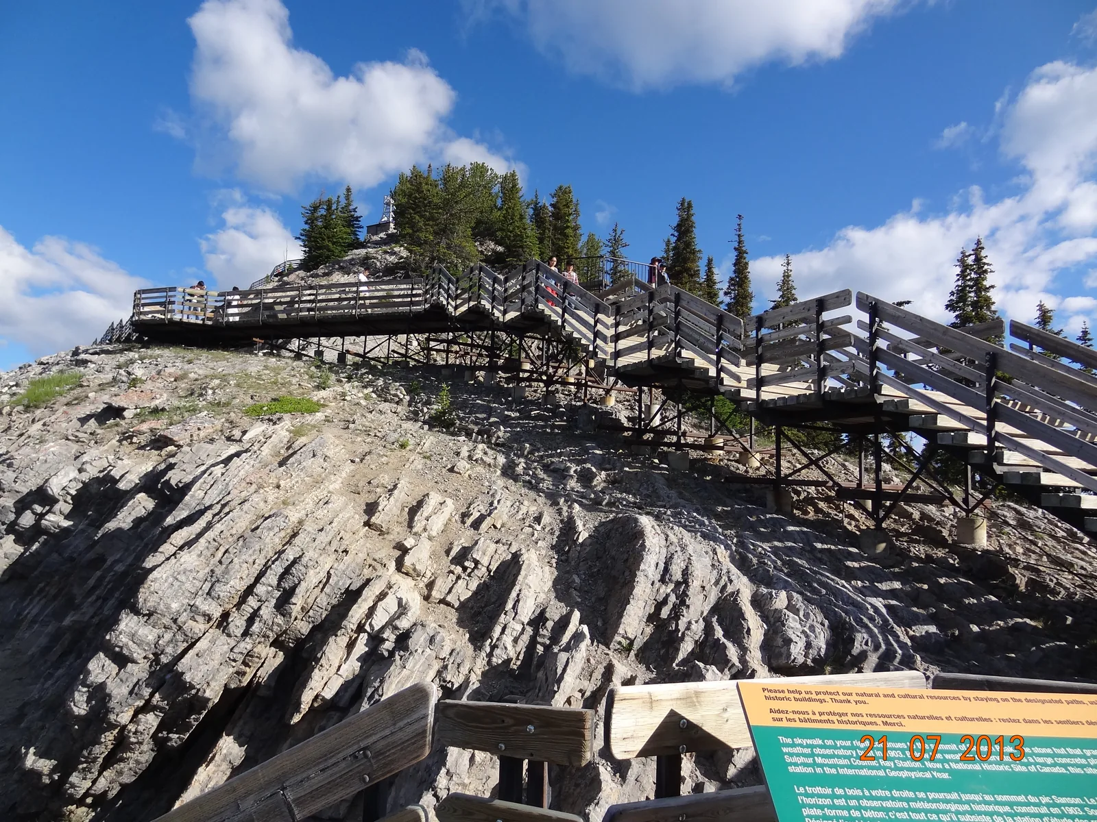 Wooden boardwalk with stairs in Banff National Park over the limestone of the ridge to the weather station.