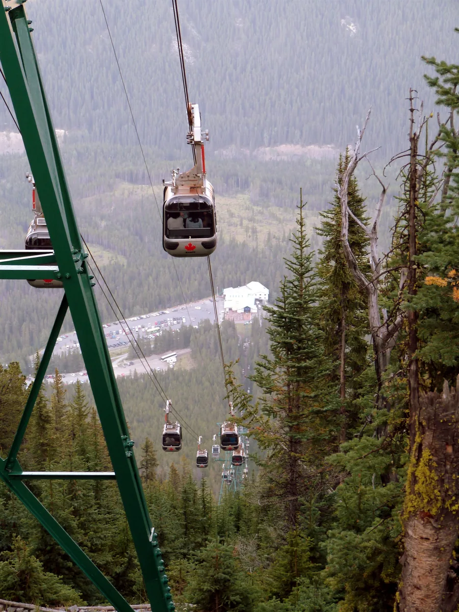 View from above in Banff National Park along the Banff Gondola cable with several cabins.