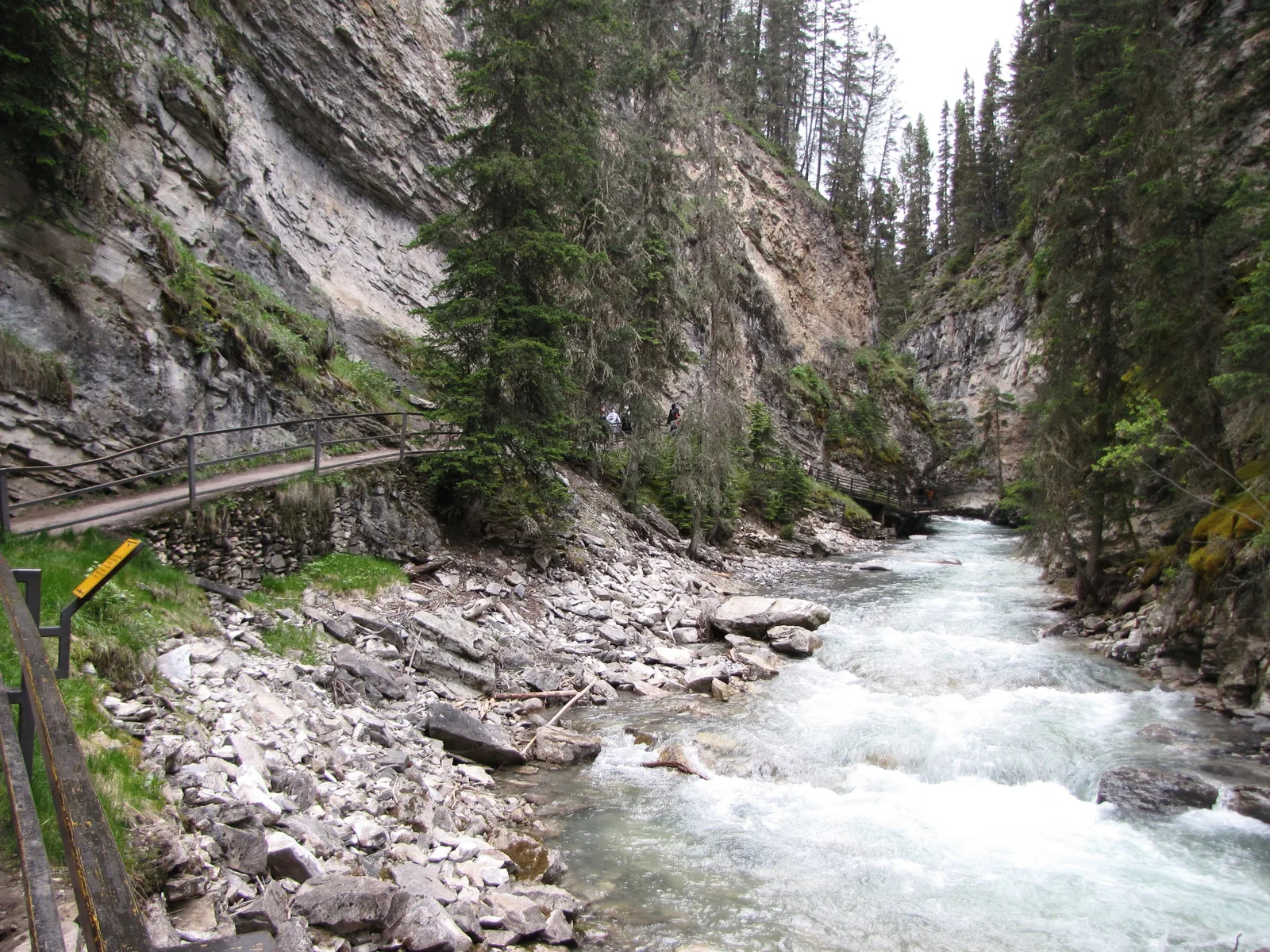 Wooden catwalk on the edge of Johnston Canyon in Banff National Park above the foaming creek.