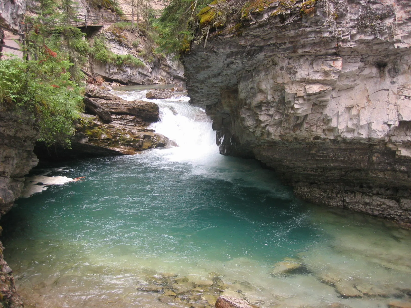 Johnston Creek flows through Banff National Park in a narrow rock gorge with a small step.