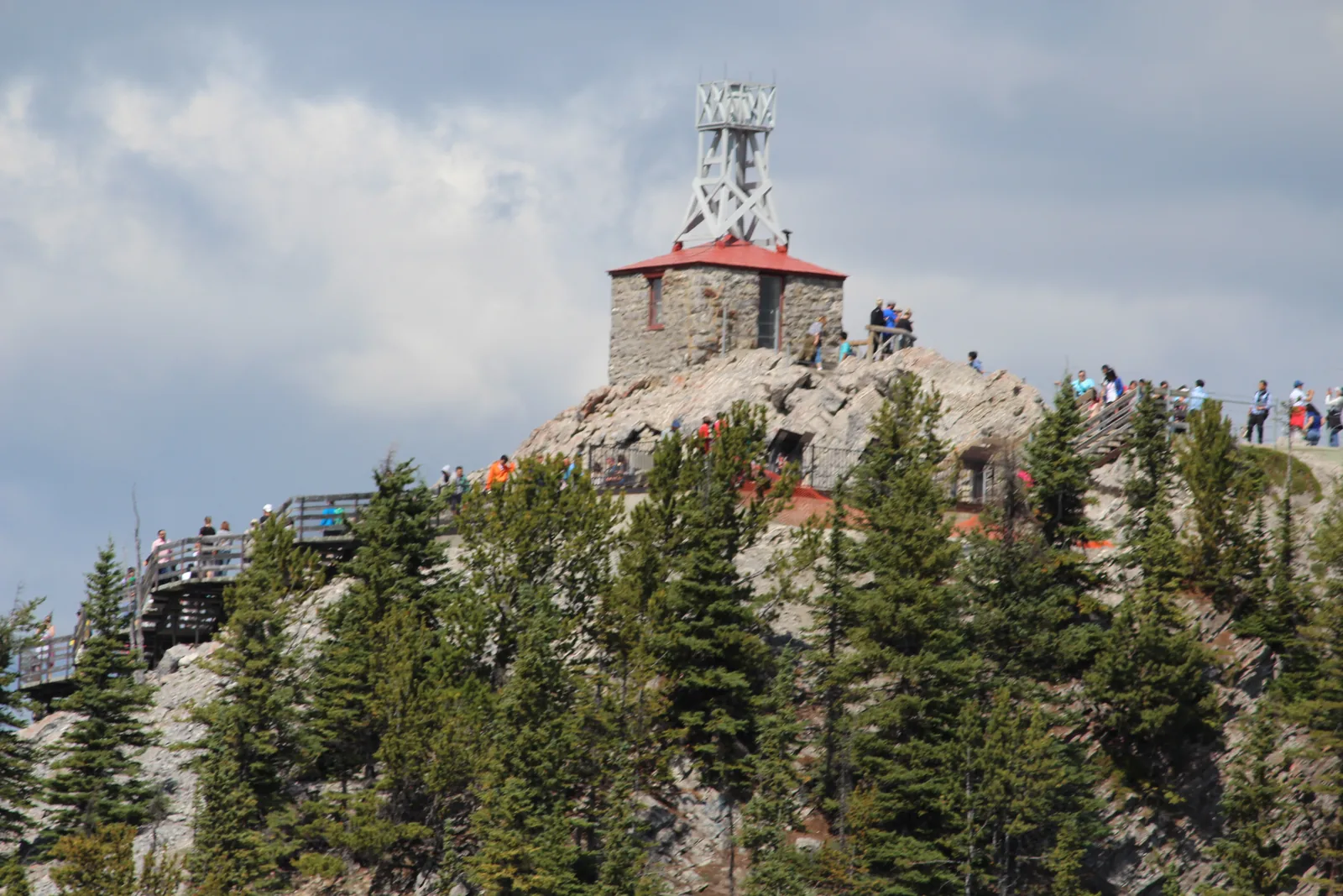 The stone weather station in Banff National Park on Sanson Peak above the forest, the boardwalk in front.