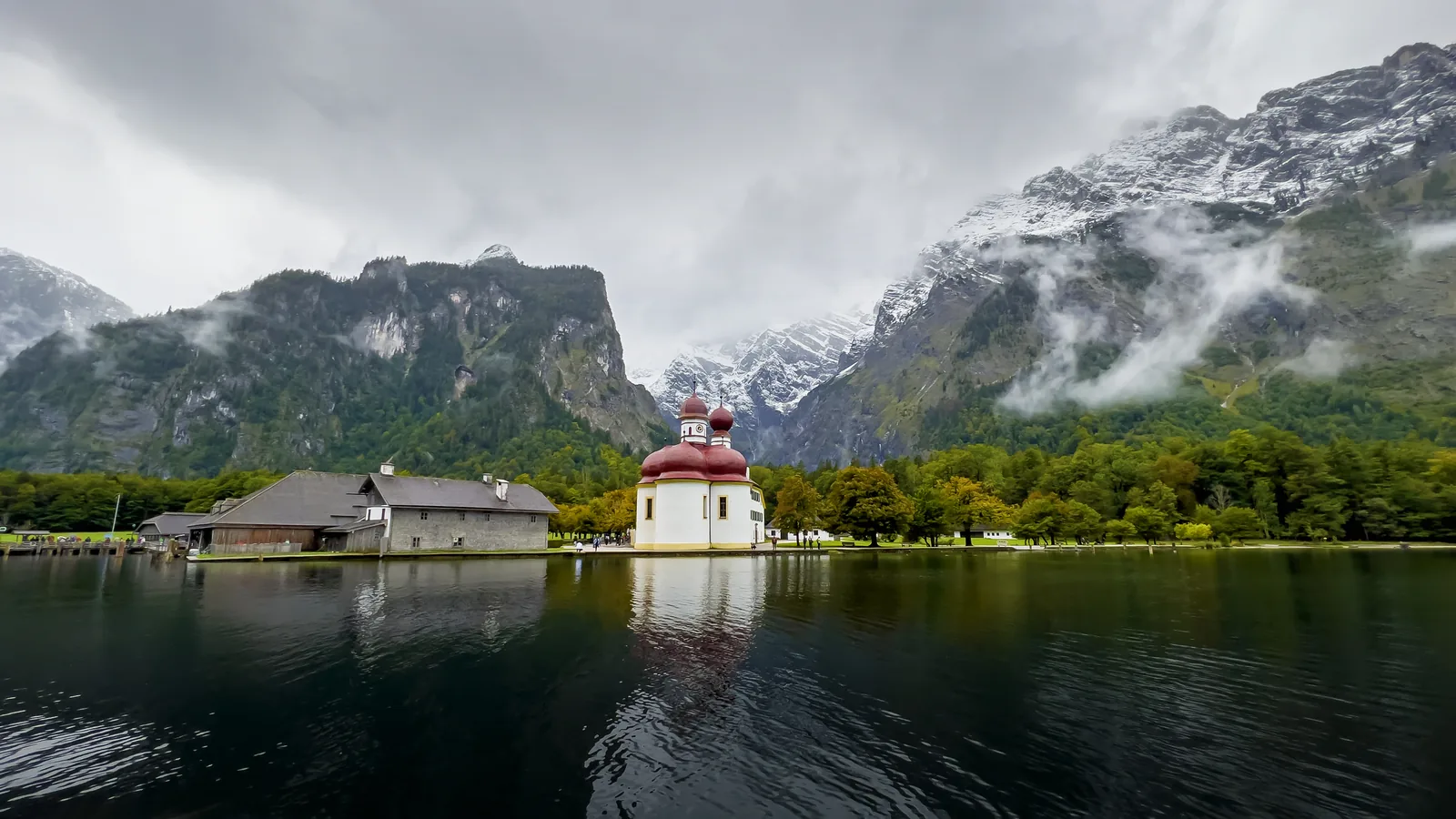 The pilgrimage church of St. Bartholomew in Berchtesgaden National Park, with its red domes, seen from Lake Königssee