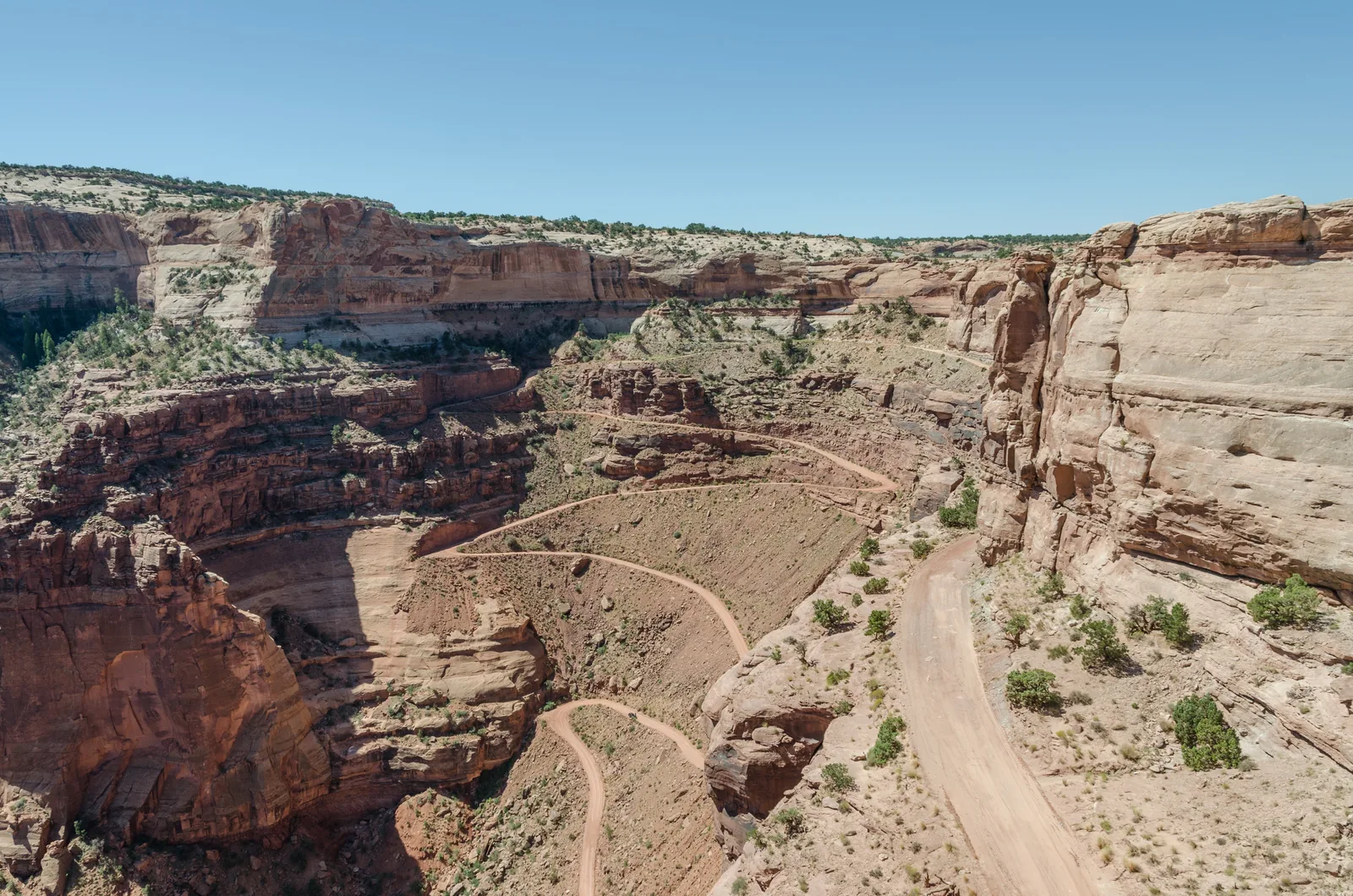The switchbacks of the Shafer Canyon Road in Canyonlands National Park, winding down the sandstone wall in tight bends