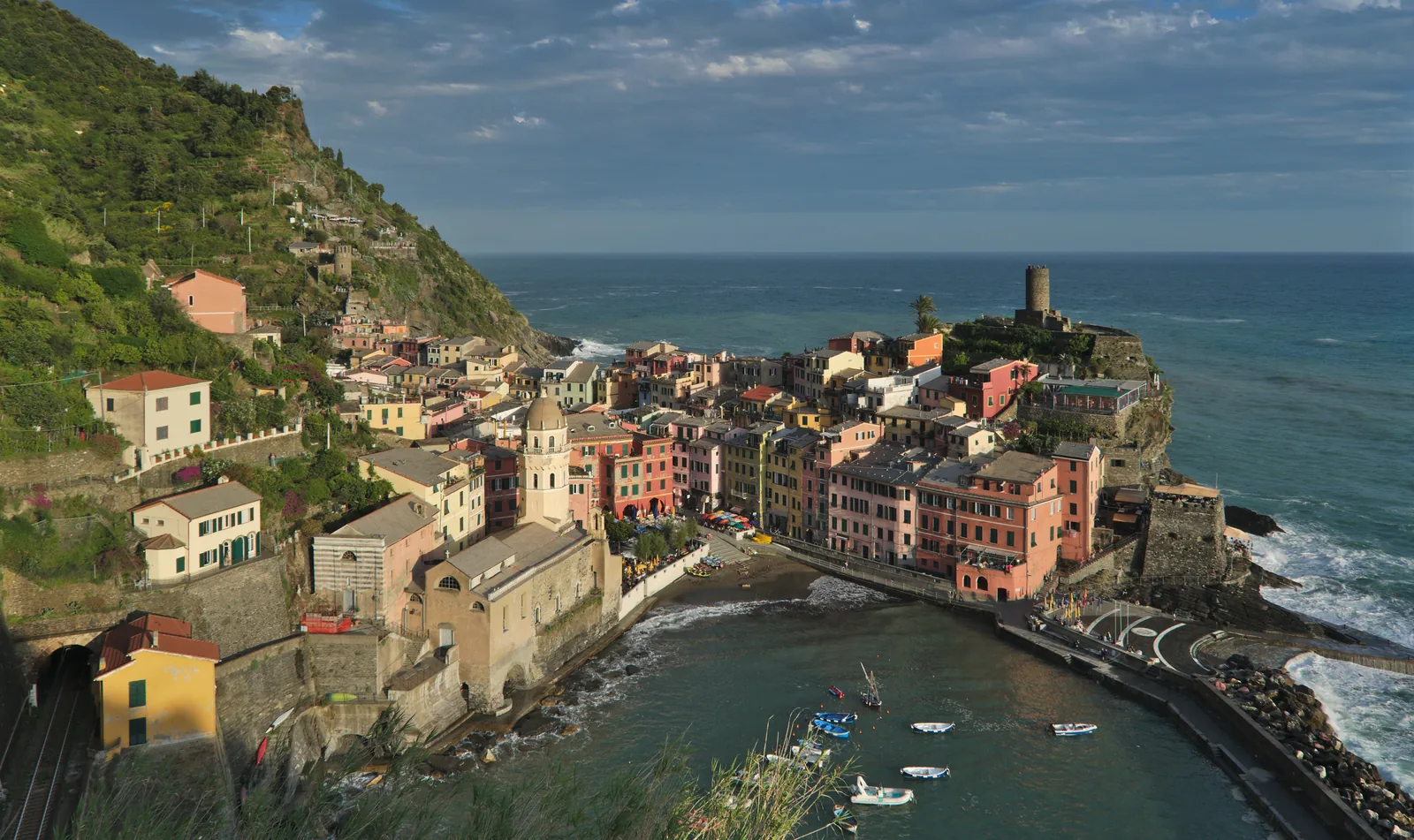View from the Sentiero Azzurro in Cinque Terre National Park of Vernazza with its small harbour and the tower on the headland