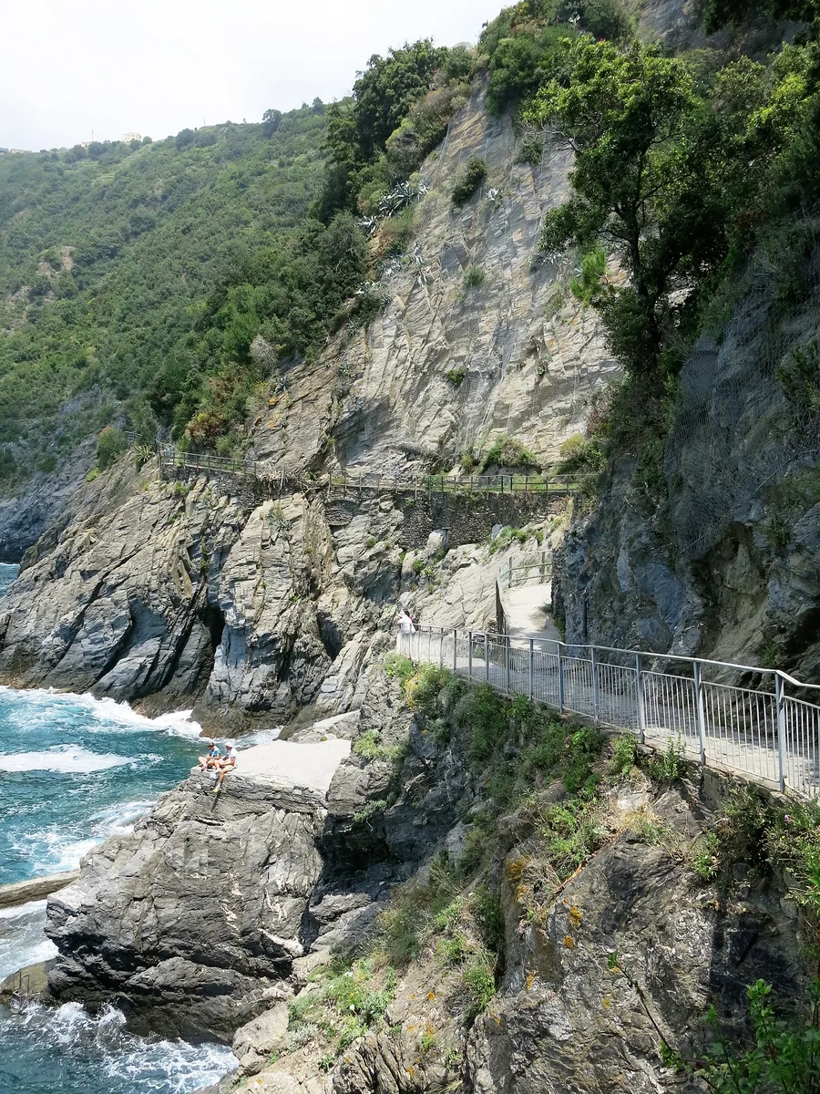 Broken coastal path between Manarola and Corniglia in Cinque Terre National Park, with rocks and surf below