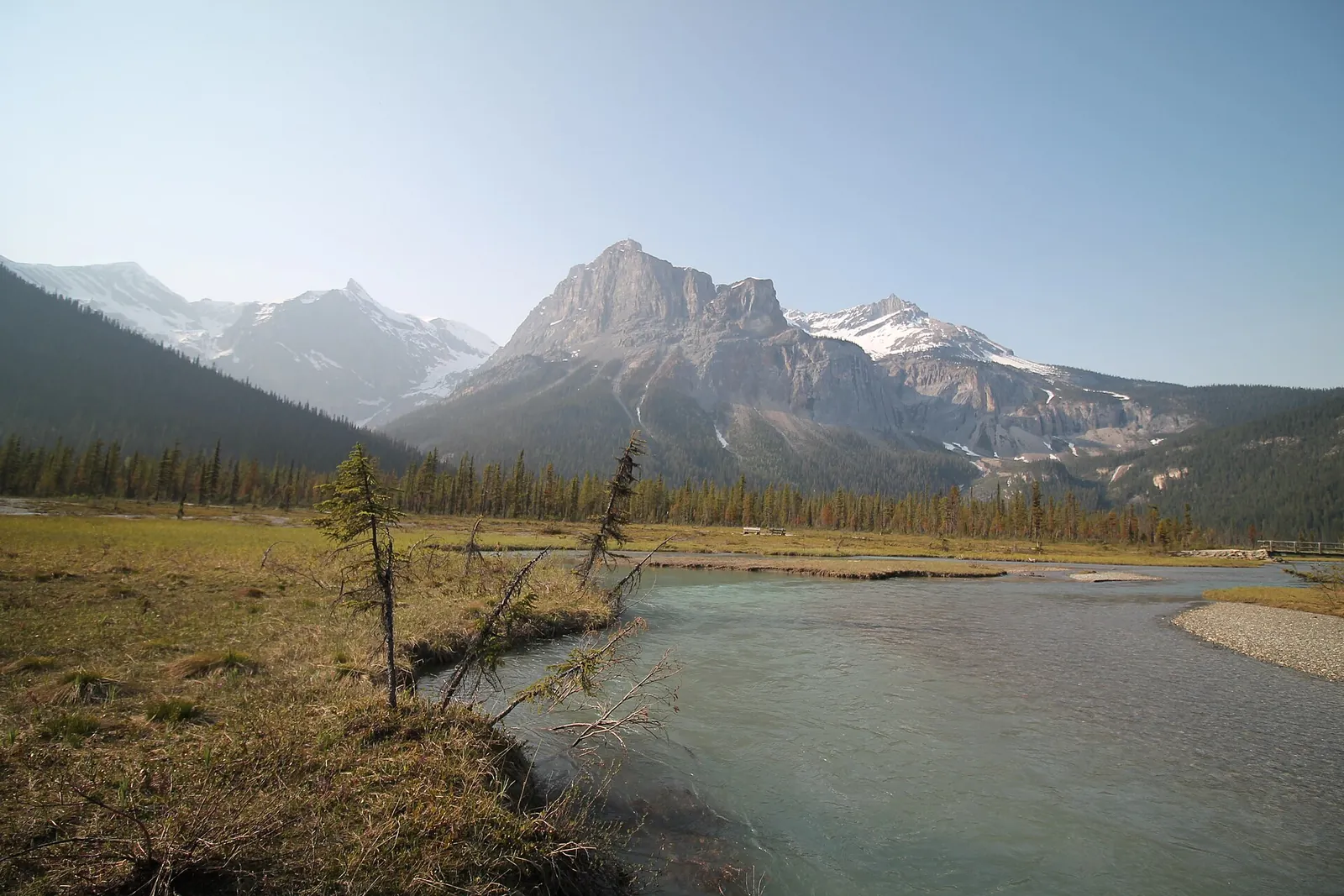 The alluvial fan at the far end of Emerald Lake in Yoho National Park: a braided creek, gravel bars and dry grass below the peaks.