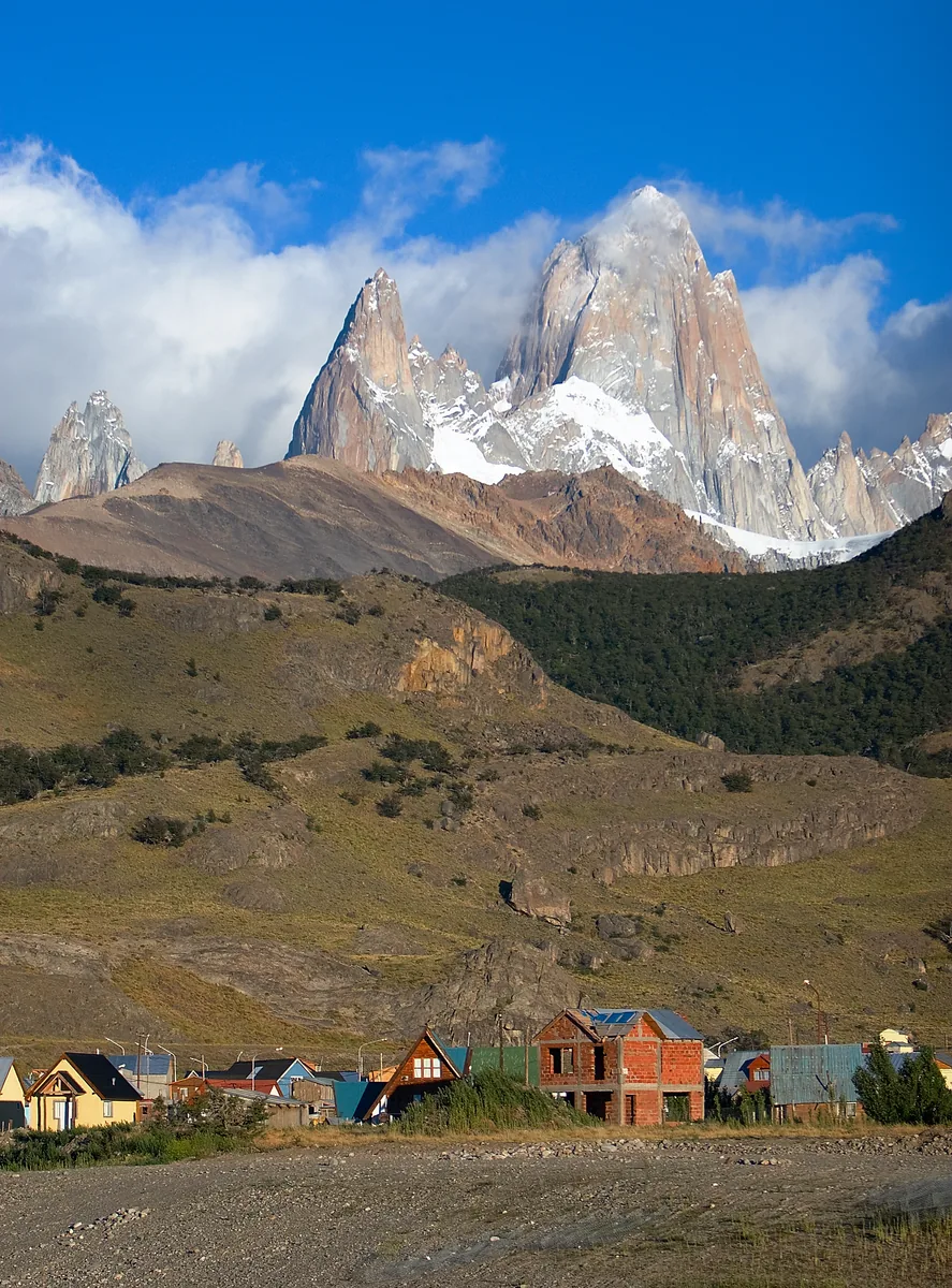Houses of El Chaltén on the edge of Los Glaciares National Park below the snowy Fitz Roy massif