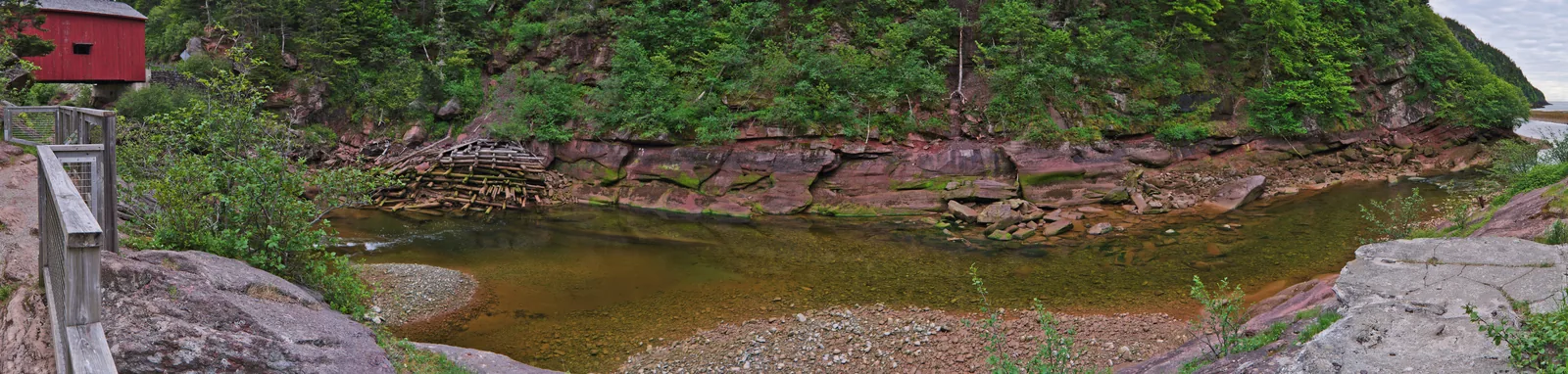 Valley of the Point Wolfe River in Fundy National Park on the Bay of Fundy: red sandstone walls, the remains of an old dam in the riverbed