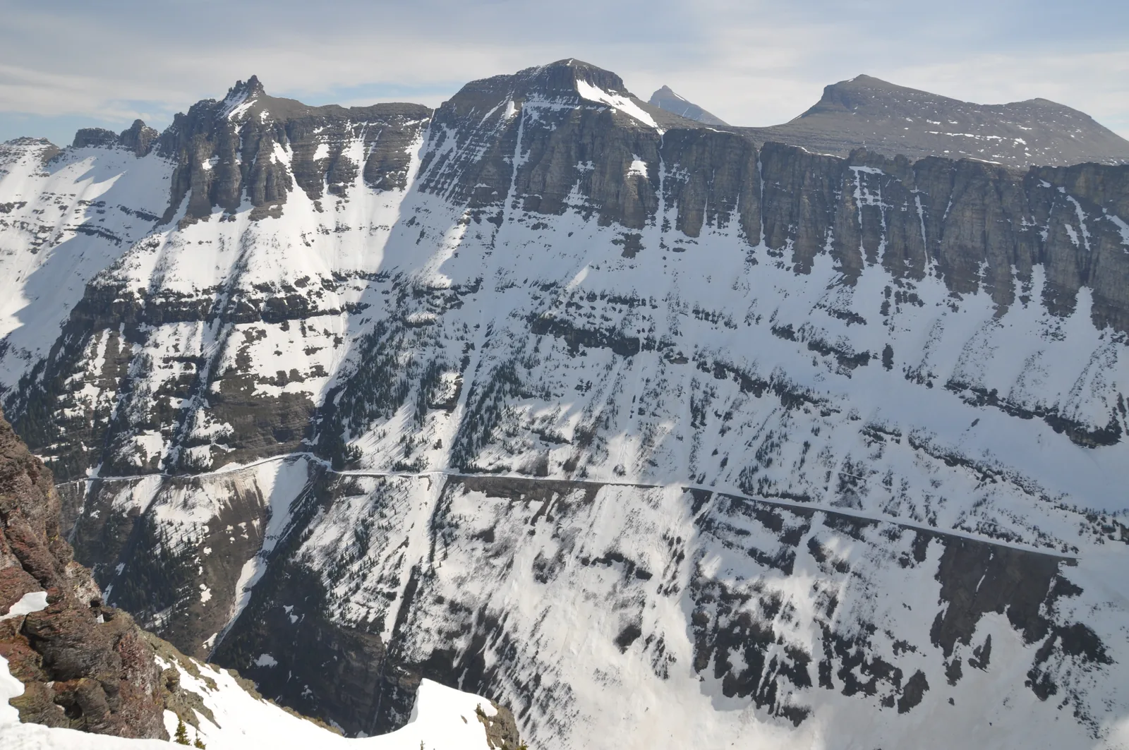 The Highline Trail in Glacier National Park, Montana, as a narrow ribbon across the snow-streaked rock face of the Garden Wall