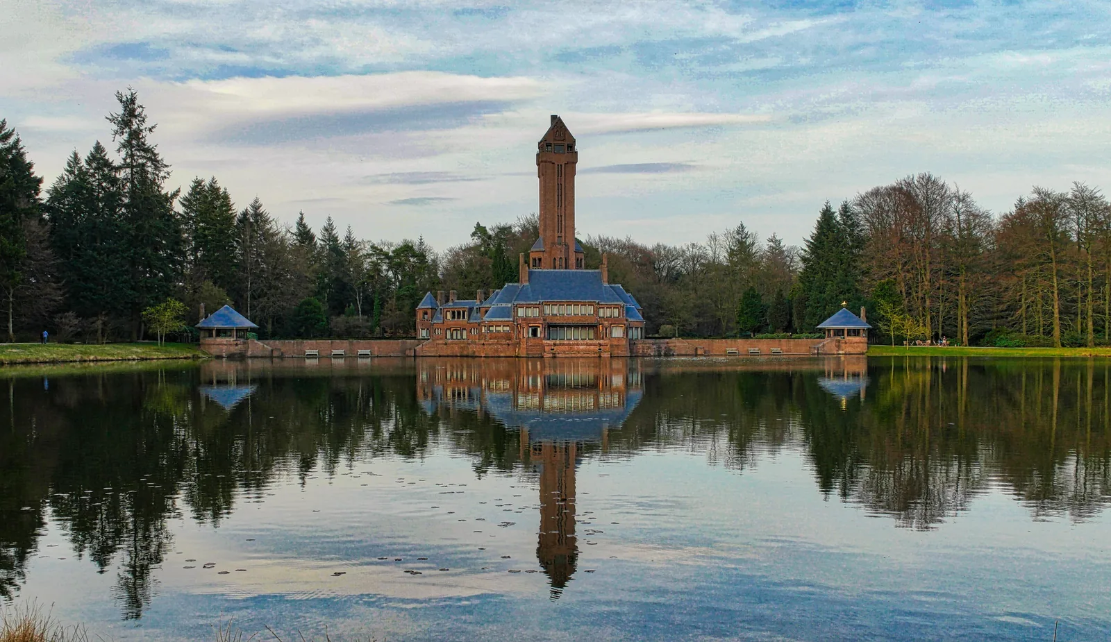 St Hubertus Hunting Lodge in De Hoge Veluwe National Park with its tower, reflected in the pond in front