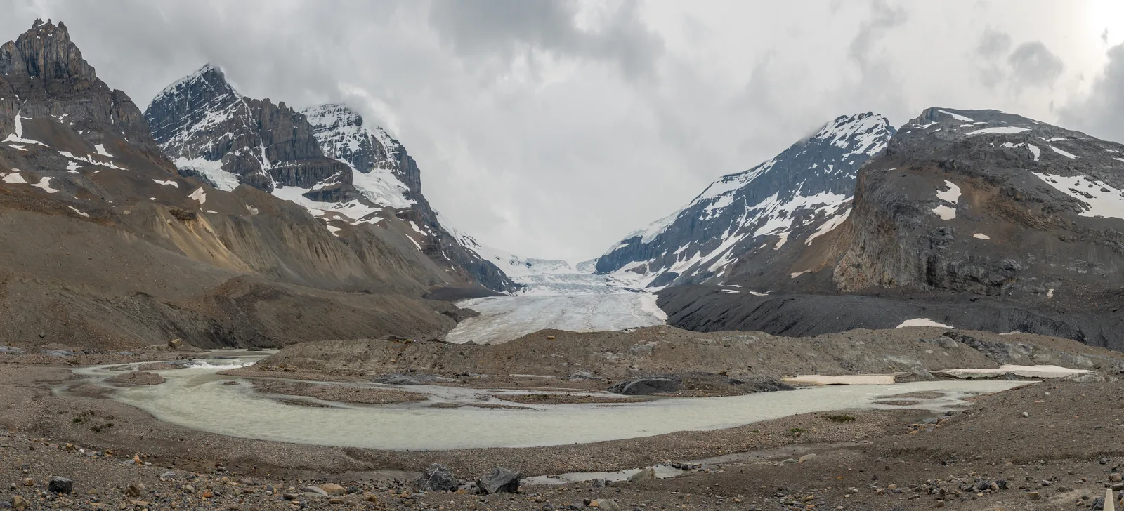 The toe of the Athabasca Glacier in Jasper National Park above the bare moraine on the valley floor