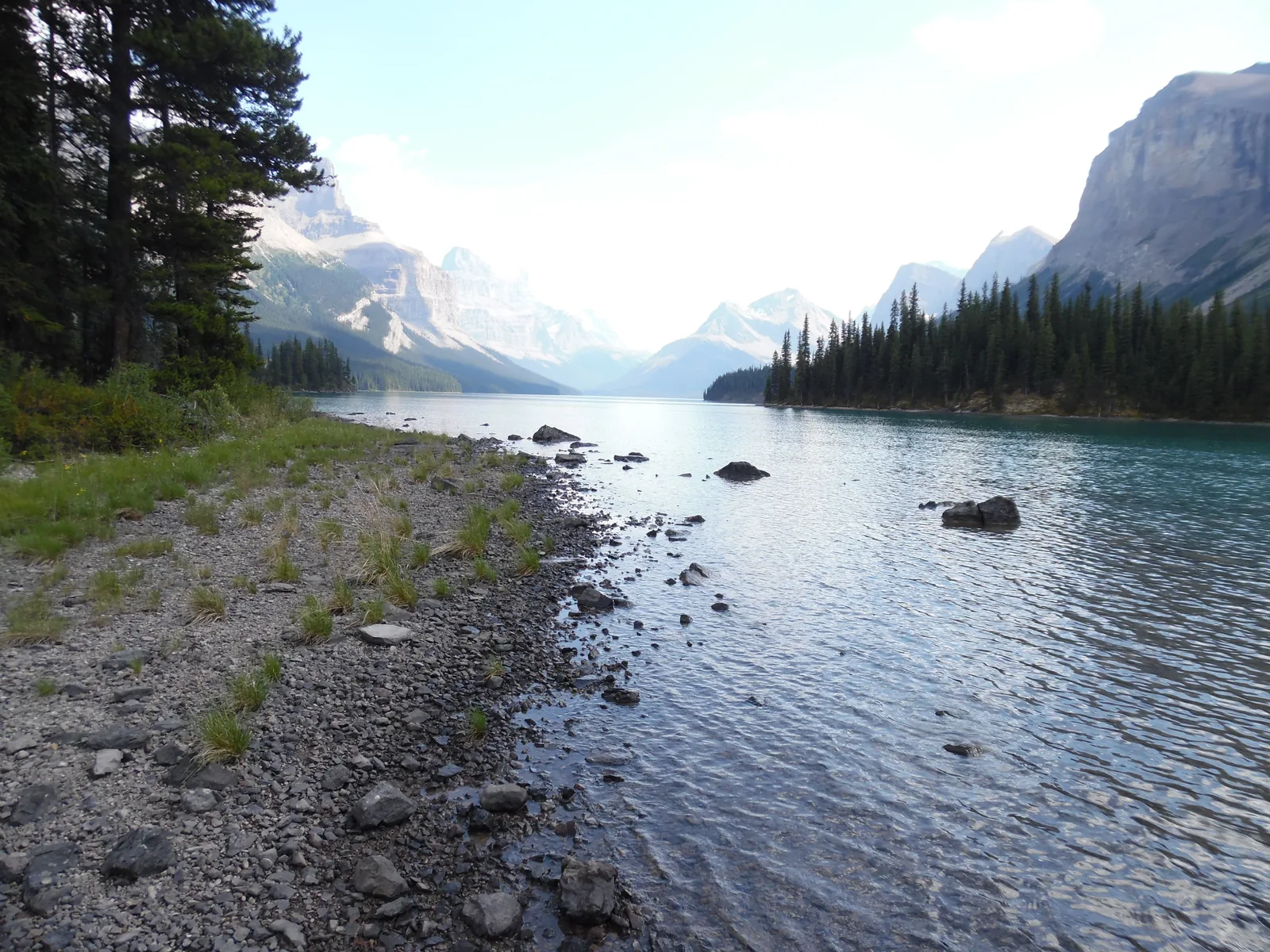 Gravel shore of Maligne Lake in Jasper National Park, the lake stretching south between mountains