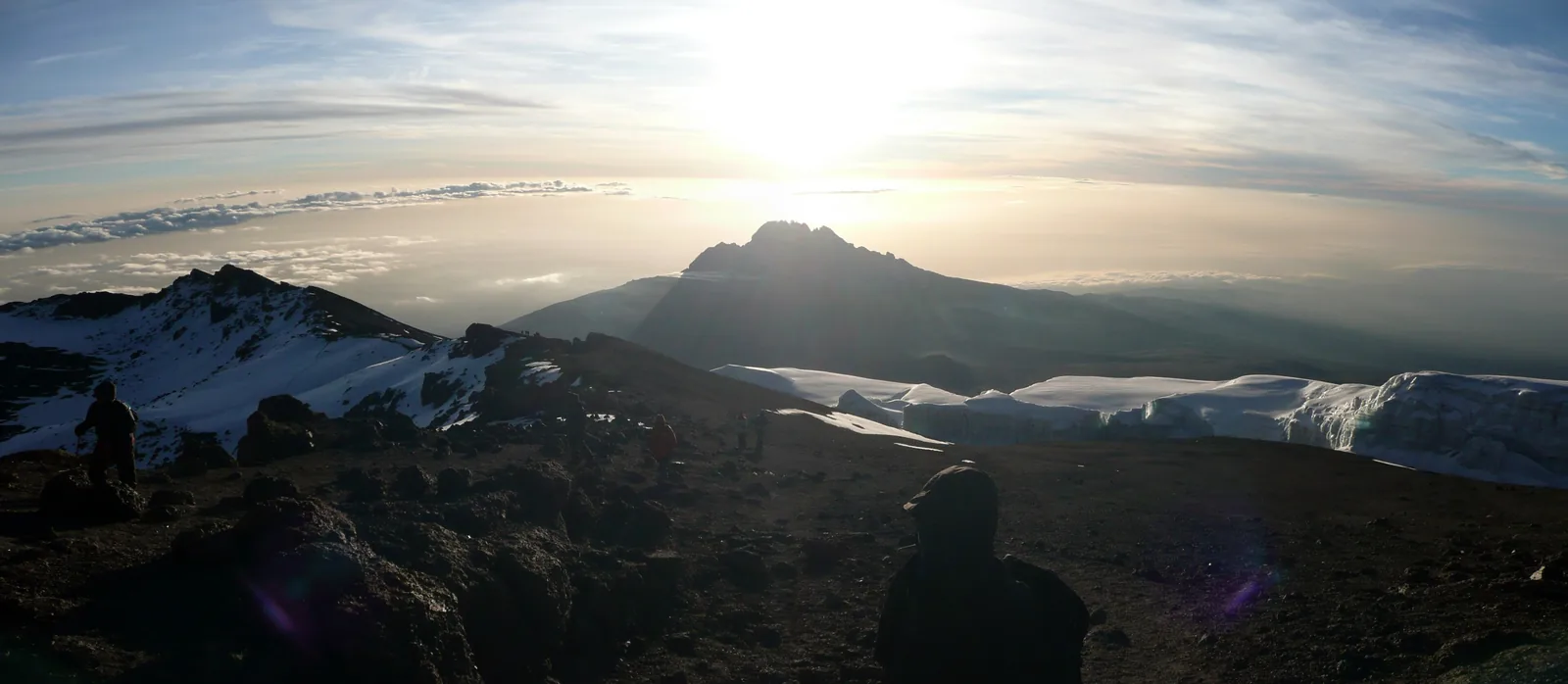 Sunrise over Mawenzi, seen from the rim of Kibo's crater in Kilimanjaro National Park, with glacier ice in the foreground