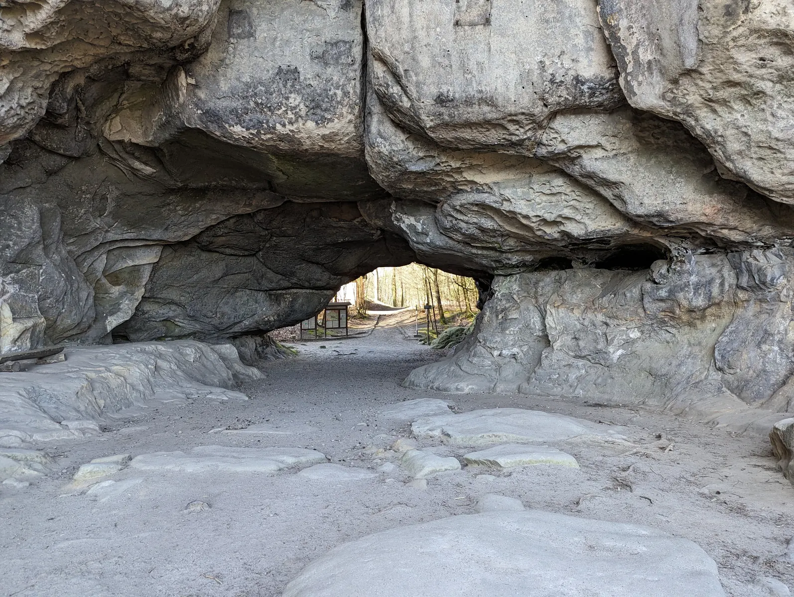 Kuhstall rock arch with its eroded sandstone ceiling and bright passage, Saxon Switzerland National Park