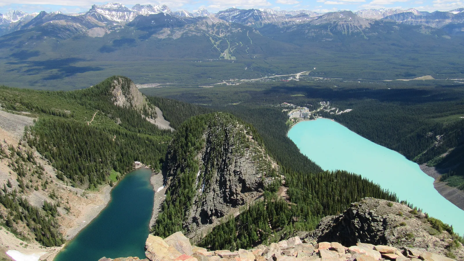 View from Devil's Thumb in Banff National Park: Lake Agnes bottom left, the Big Beehive in the middle and turquoise Lake Louise with the hotel on the right.
