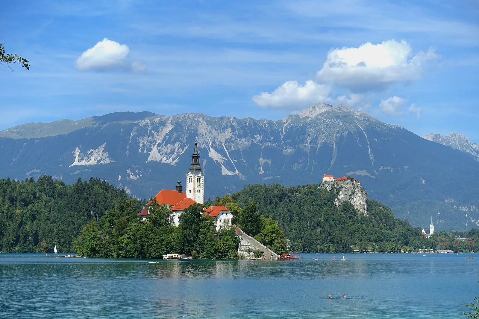 Bled Island in Lake Bled with its pilgrimage church, Bled Castle on its rock behind and the Karawanks mountains