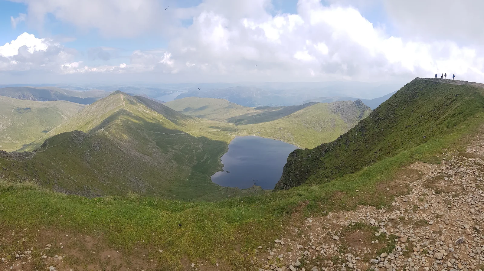 View from Helvellyn in the Lake District National Park down to the tarn Red Tarn between the ridges Swirral Edge and Striding Edge