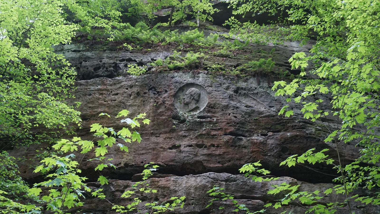 A plaque carved into the rock near the Bastei on the Malerweg
