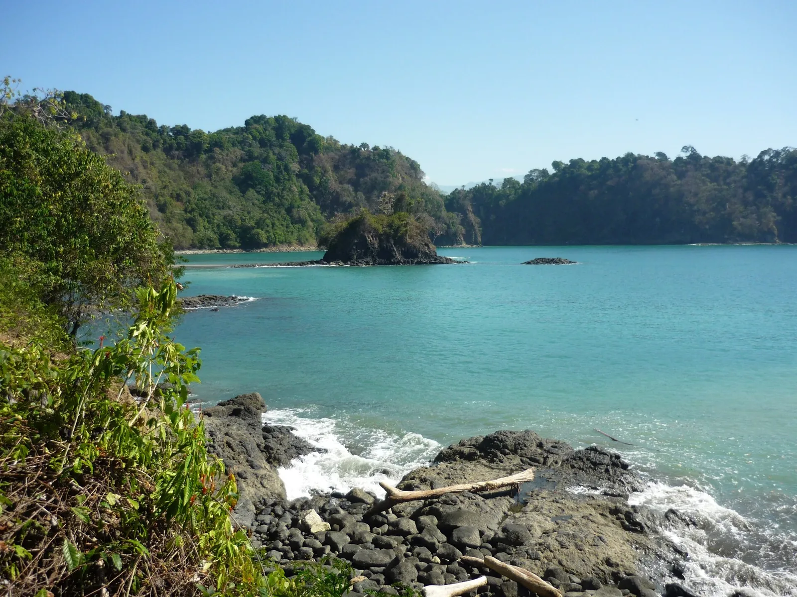 View of the Puerto Escondido bay in Manuel Antonio National Park with rocks and forest