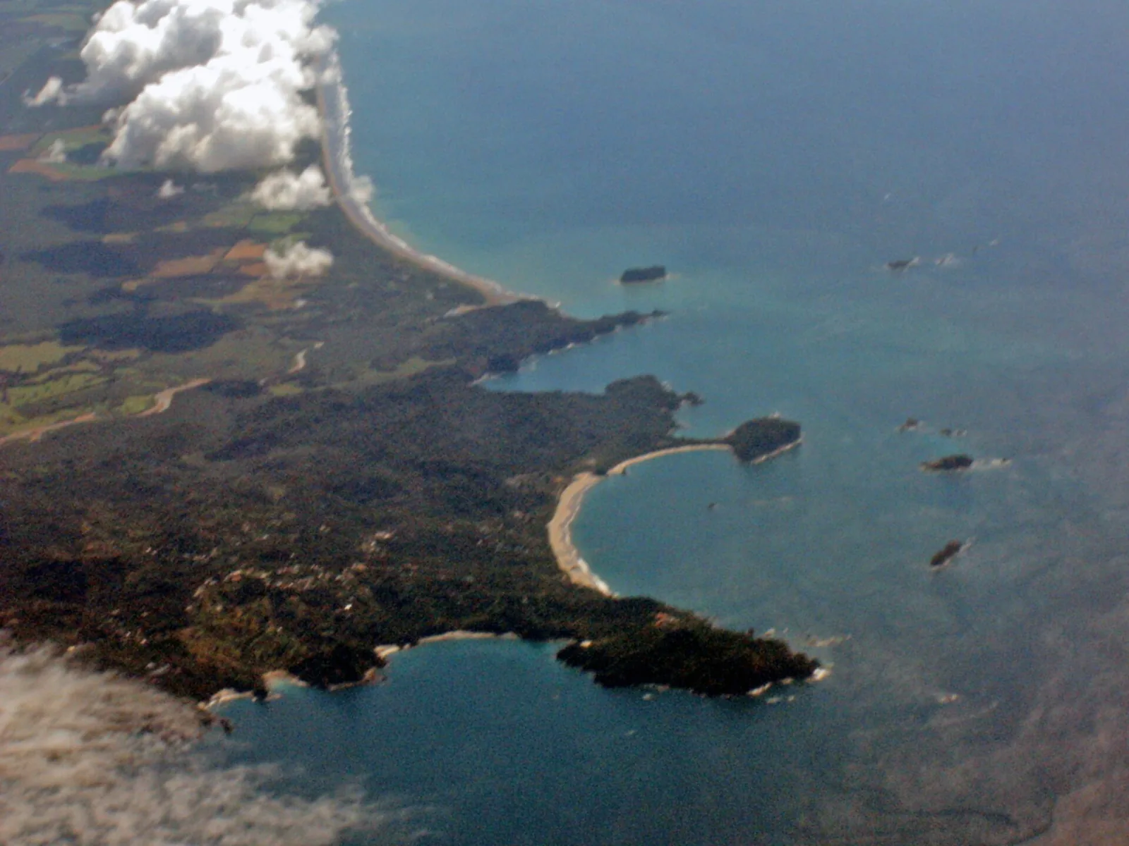 Aerial view of the Punta Catedral headland in Manuel Antonio National Park with beaches on either side