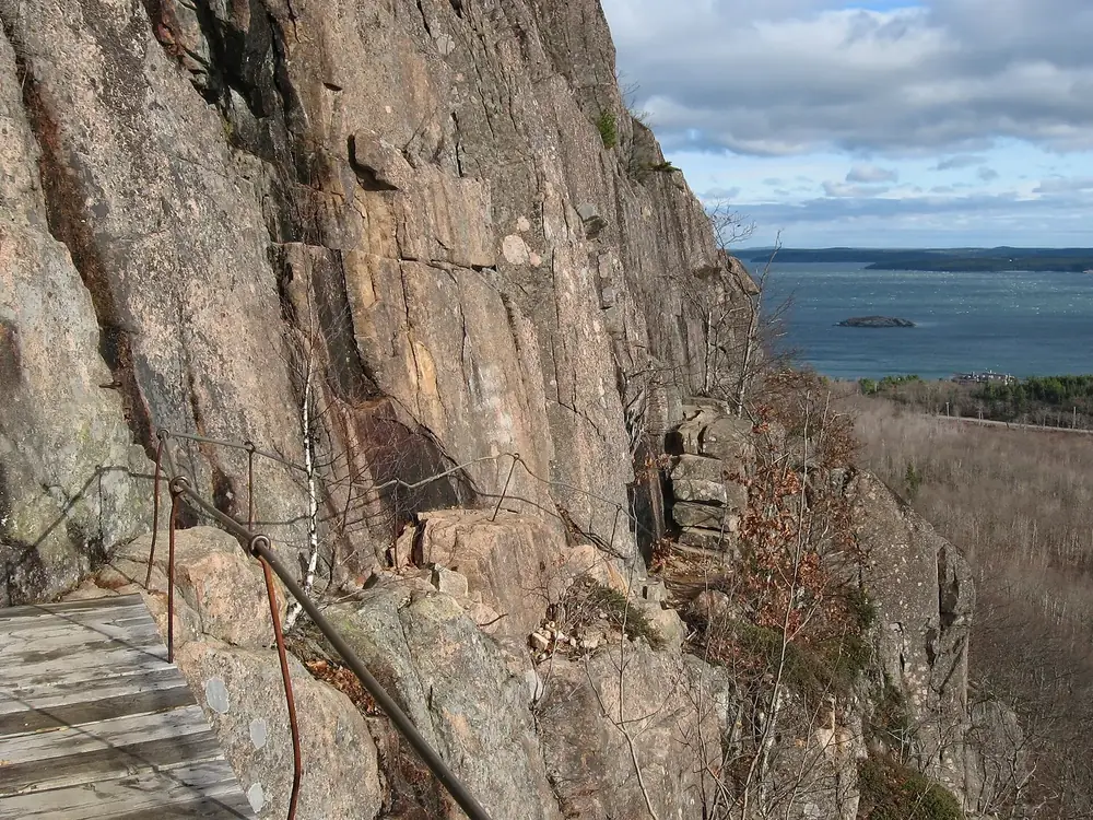 Precipice Trail in Acadia National Park, on the east face of Champlain Mountain: wooden steps and iron railings on reddish granite