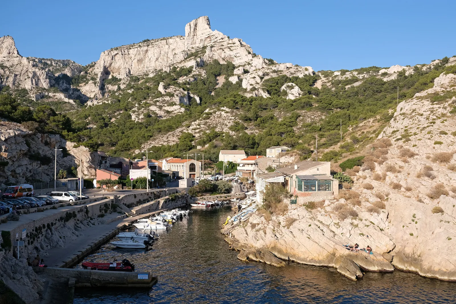 The small harbour of Callelongue at the western end of Calanques National Park: boats below houses, pale limestone crags above