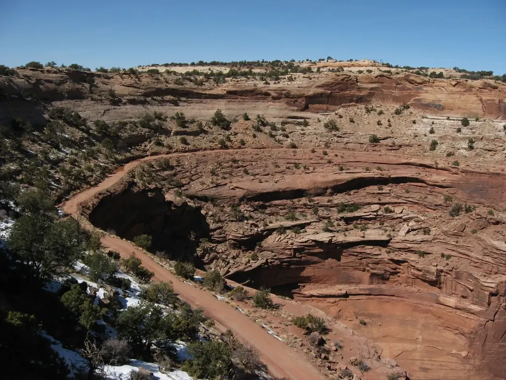 View from Shafer Canyon Overlook in Canyonlands National Park of the Shafer Trail switchbacks between red rock ledges