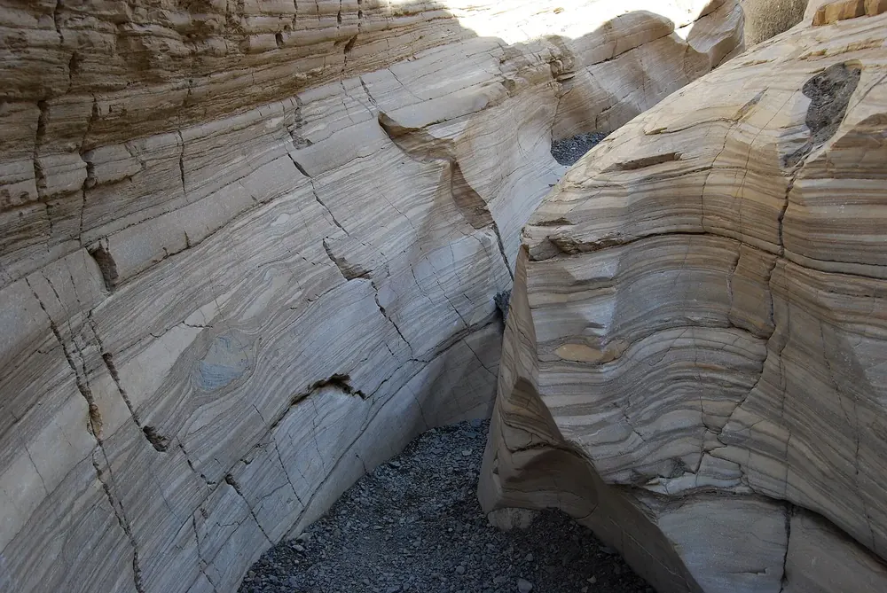 Mosaic Canyon in Death Valley National Park: smoothly polished, marbled walls of pale rock at a narrow point in the canyon