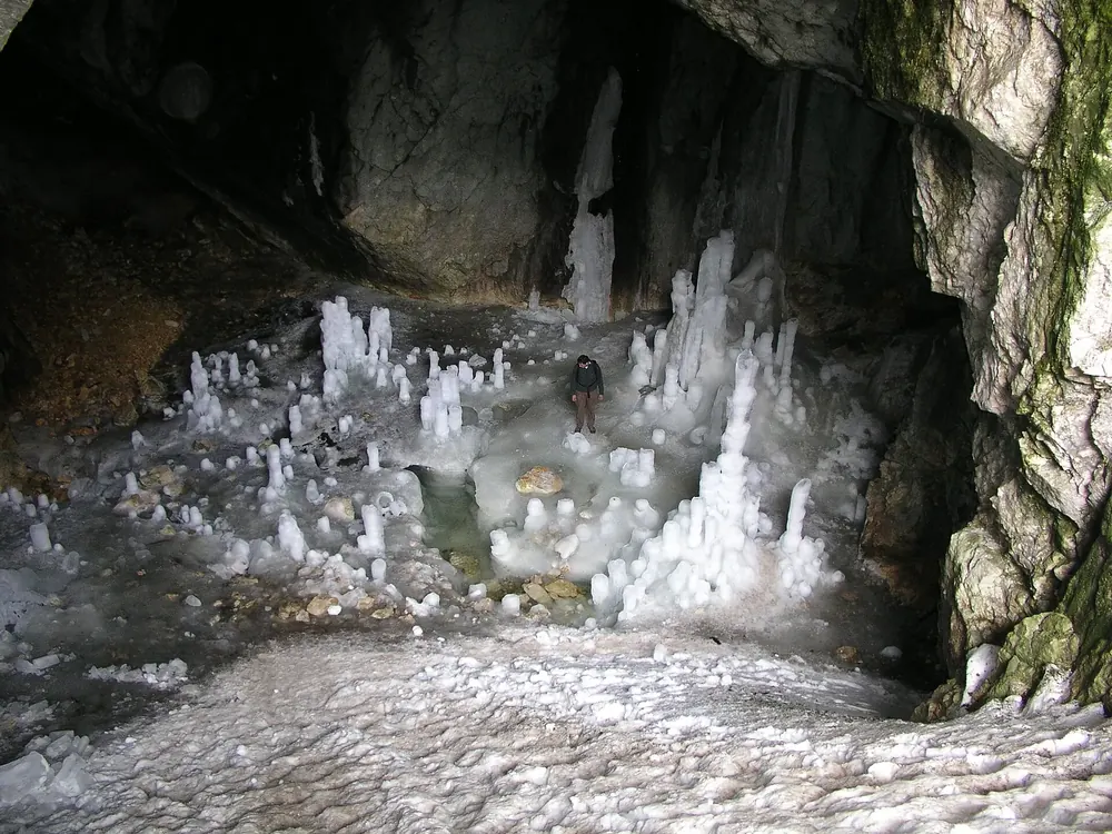 Ledena pećina in Durmitor National Park: ice columns and ice stalagmites inside the ice cave, a layer of ice on the floor