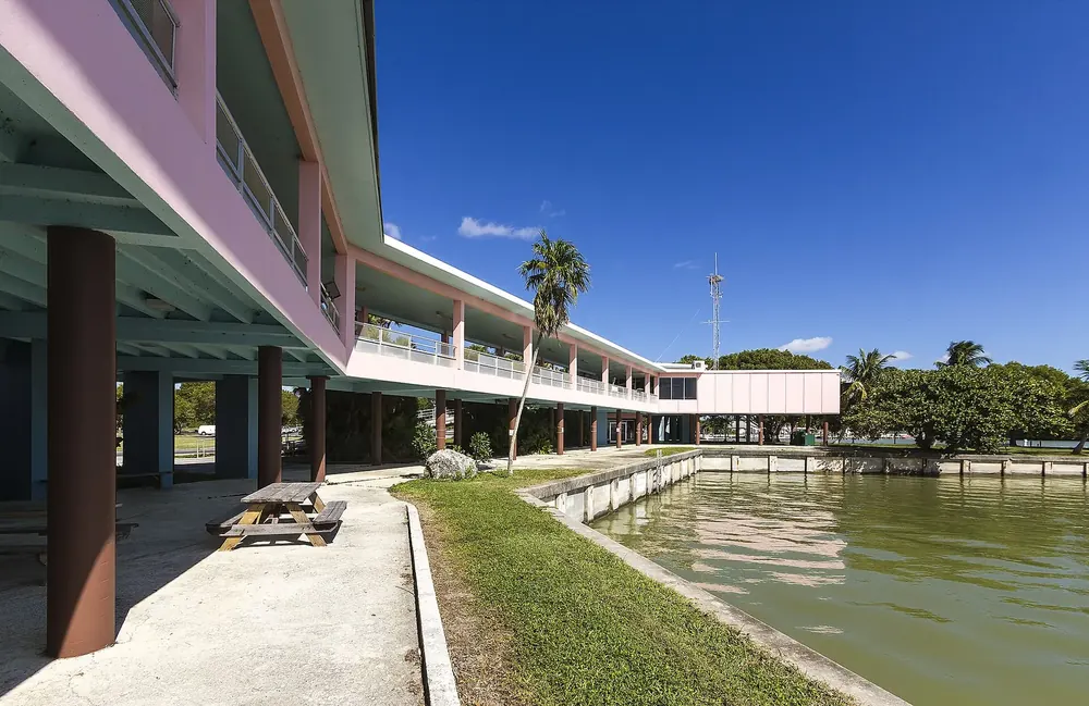 Flamingo Visitor Center (Guy Bradley Visitor Center) in Everglades National Park: two-storey building on stilts by the water with palms