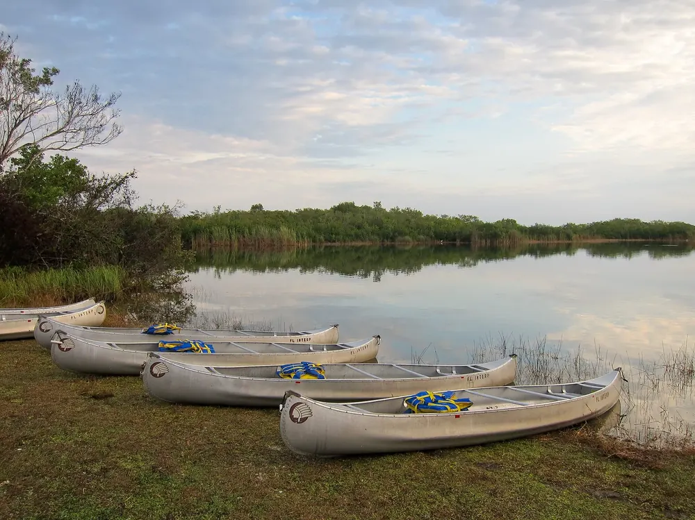 Canoes on the shore of Nine Mile Pond in Everglades National Park, start of the canoe trail through mangroves and marsh