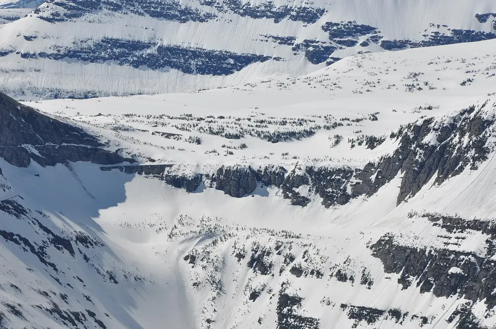 Oberlin Bend in Glacier National Park, Montana, in spring: deep-snow mountain slopes with rock bands above the valley on the Going-to-the-Sun Road