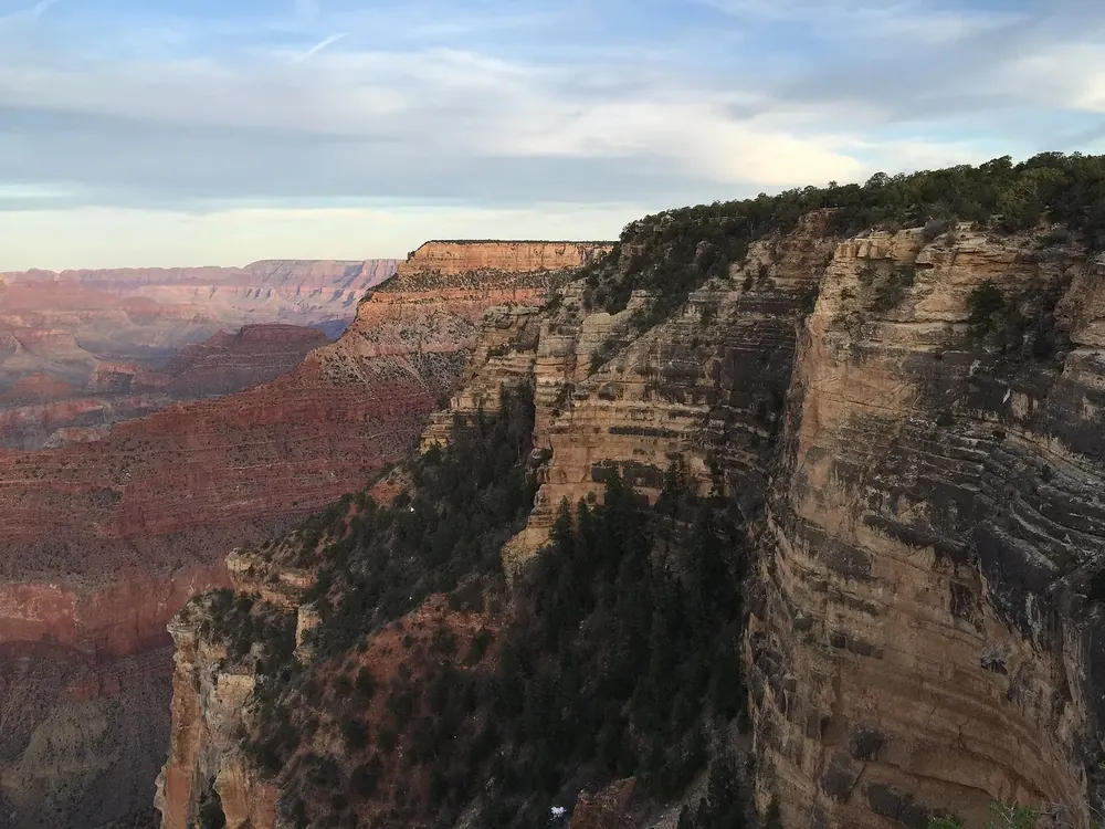 View from Yavapai Point in Grand Canyon National Park, east over stepped rock walls and canyons, in evening light
