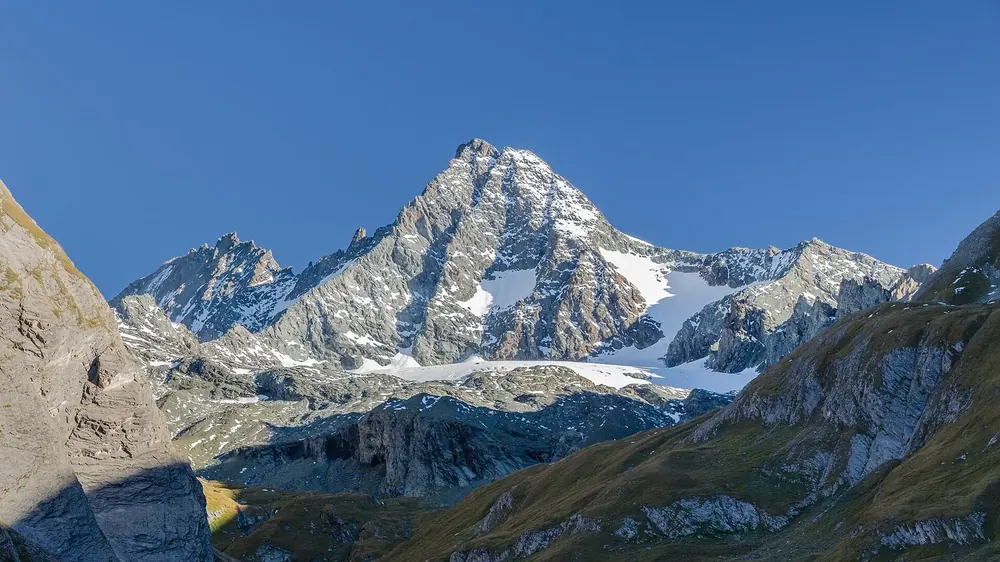 View from the Lucknerhaus car park in Hohe Tauern National Park to the Grossglockner with glaciated flanks above green slopes