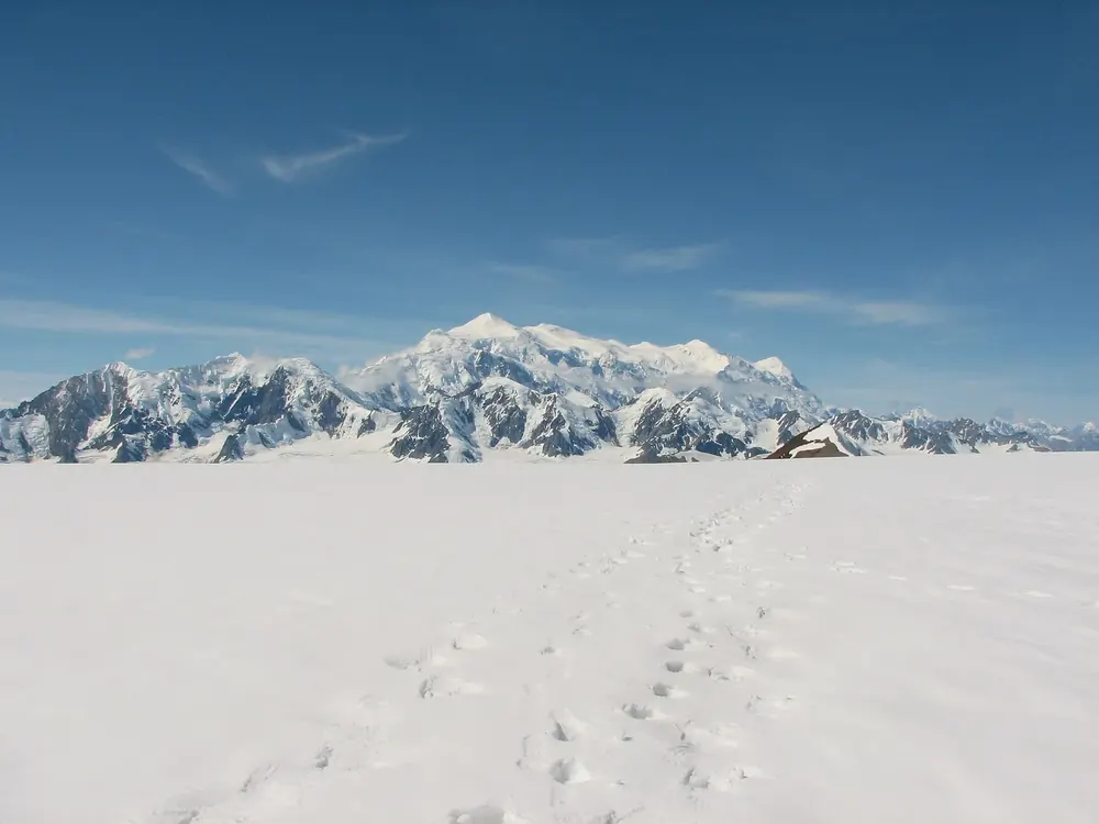 Mount Logan in Kluane National Park from the north-east: glaciated massif above the vast Kluane Icefield with footprints in the snow