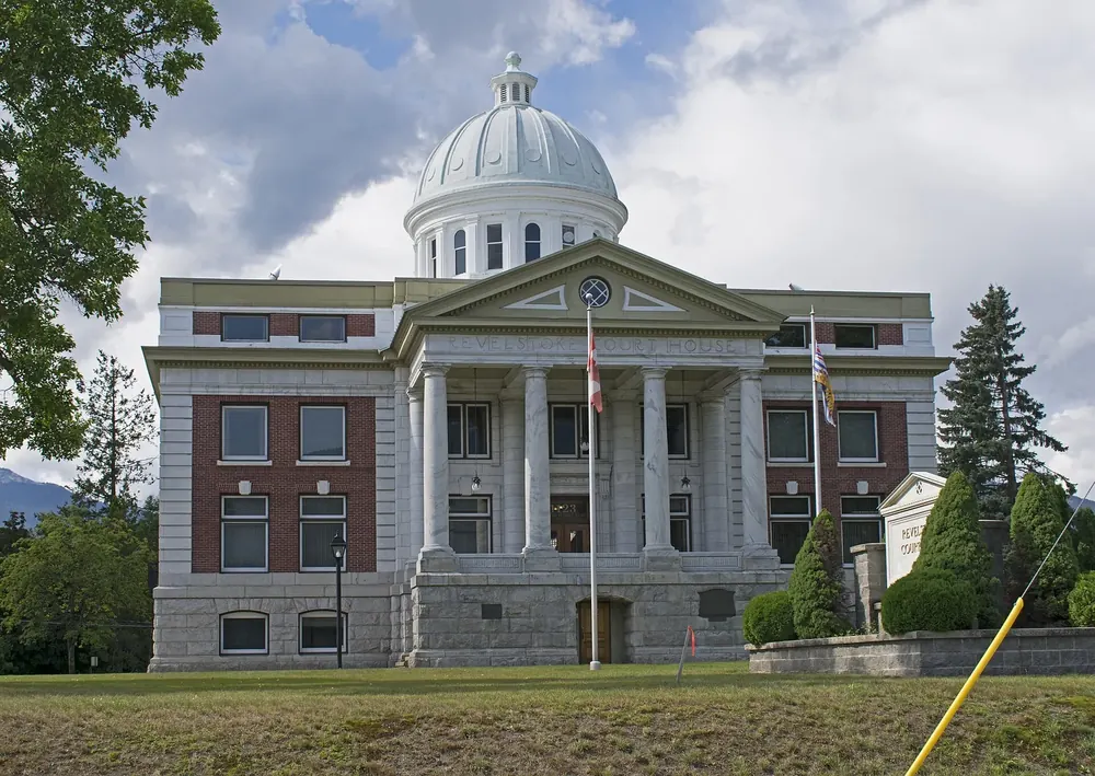 Revelstoke Courthouse near Mount Revelstoke National Park: a neoclassical courthouse with a columned portico and dome among trees