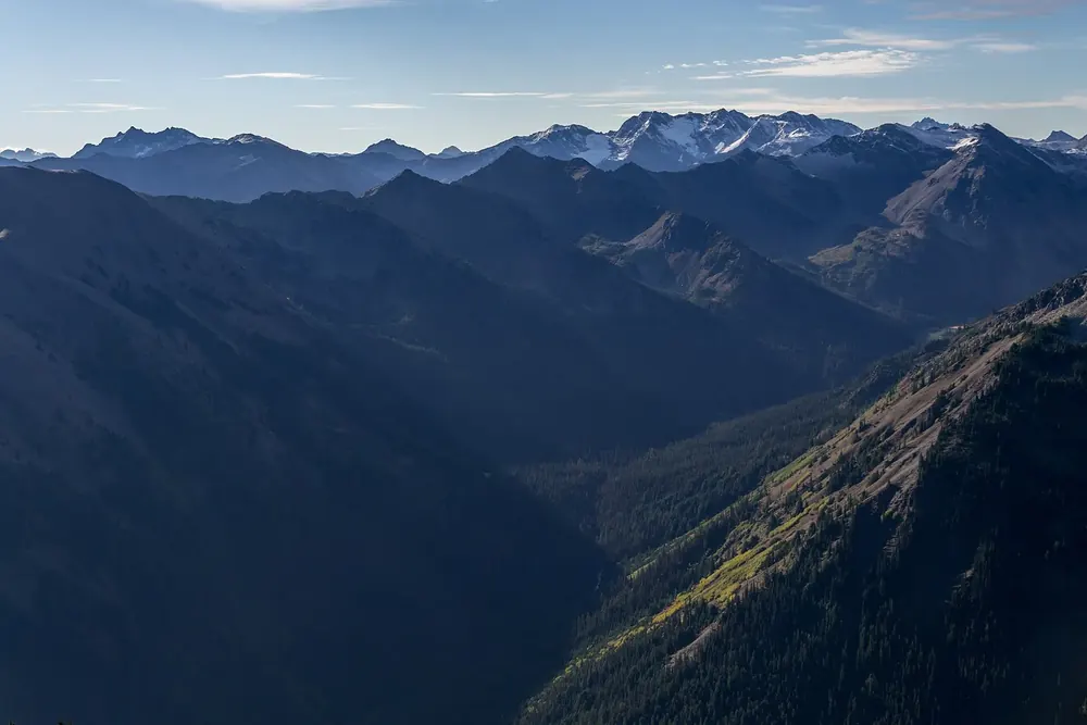 View from the Obstruction Point trailhead in Olympic National Park into deeply cut valleys, with the ridges of the Olympic Mountains behind