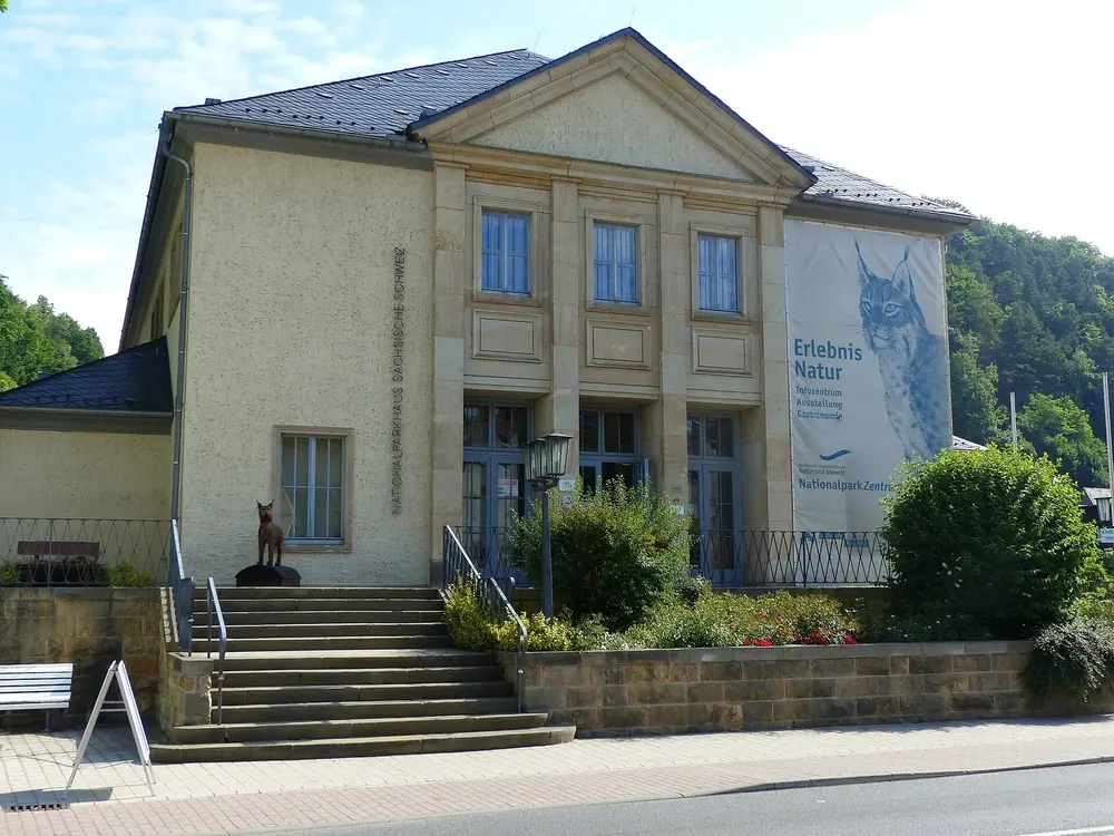 National Park Centre in Bad Schandau: a neoclassical building with an outside staircase and a large banner reading Erlebnis Natur