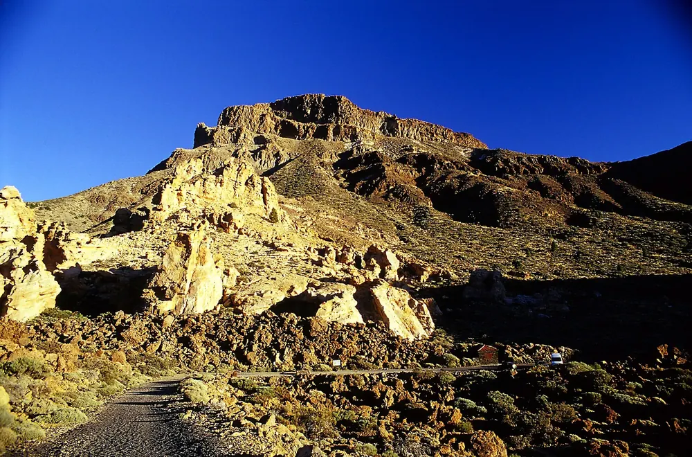 Climb to the Degollada de Guajara in Teide National Park: yellow rocks of Piedras Amarillas below the rock face of the Guajara massif