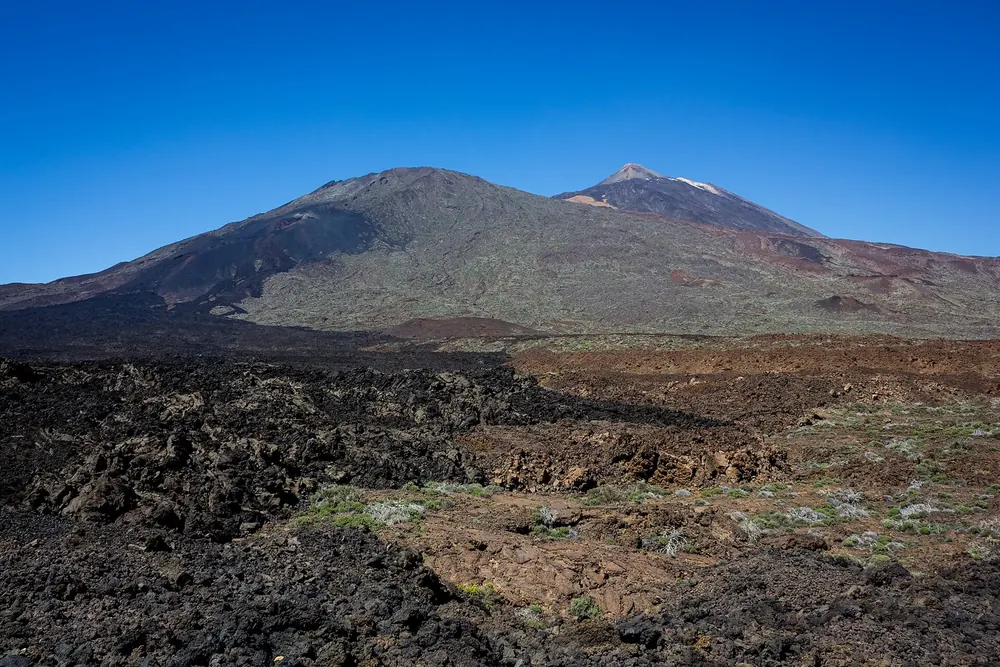 Pico Viejo with the Narices del Teide in Teide National Park and dark lava flows from 1798, the summit of Teide behind