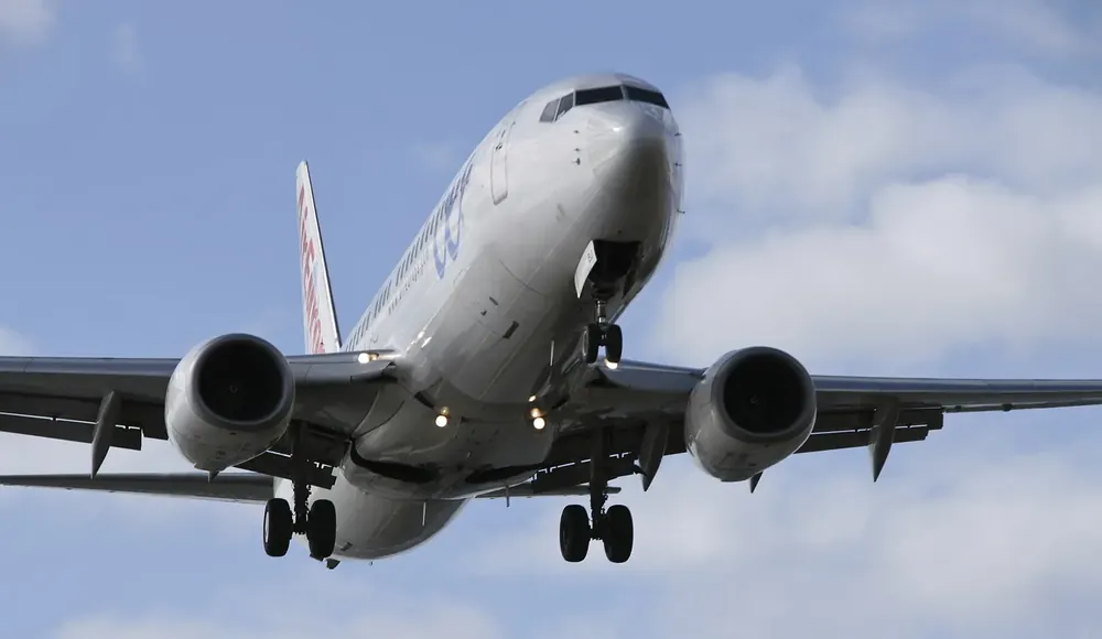 Airliner on approach to César Manrique Airport near Arrecife against a cloudy sky
