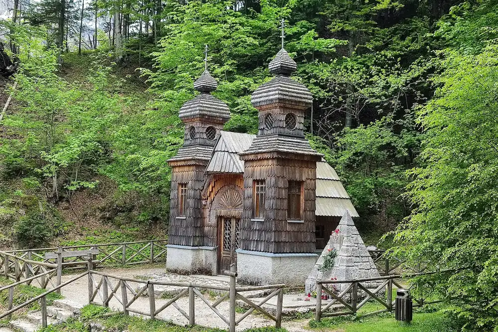 Russian Chapel on the Vršič Pass in Triglav National Park: wooden chapel with two small onion domes and a shingle roof in beech woodland