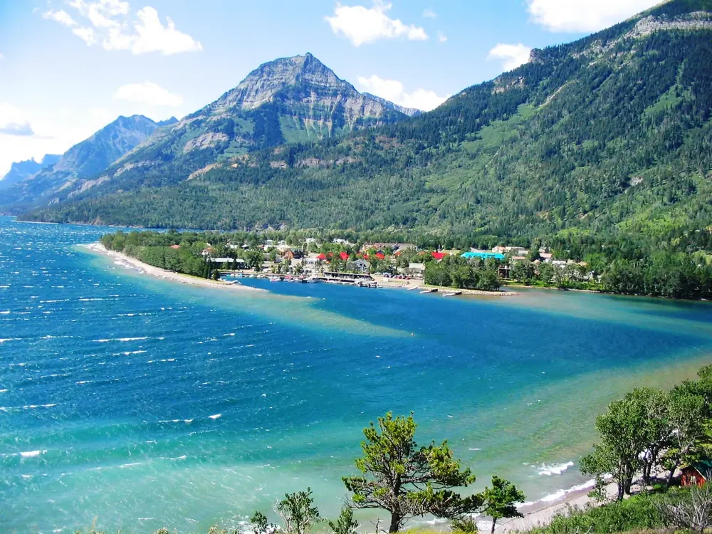 View from the Prince of Wales Hotel in Waterton Lakes National Park of Waterton Park on turquoise Upper Waterton Lake below forested mountains