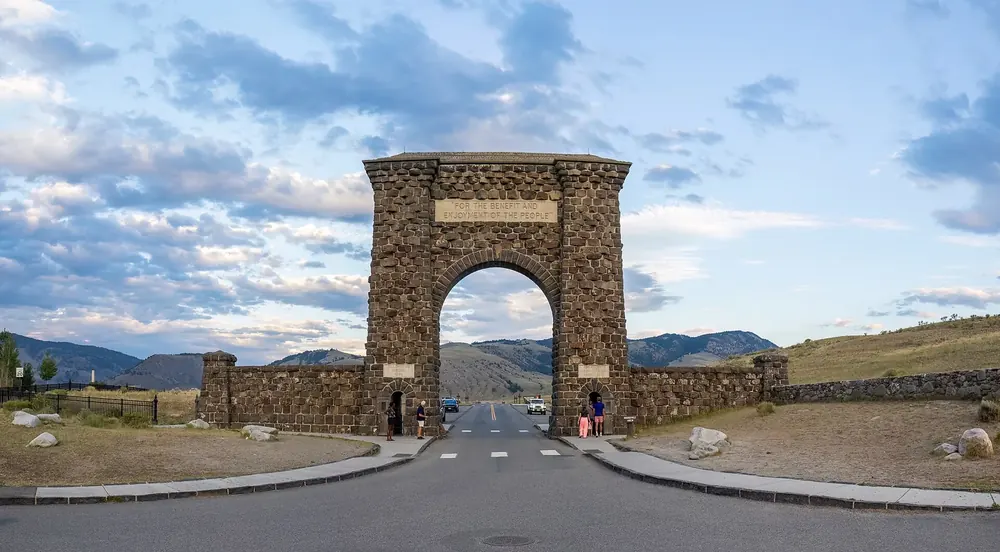 Roosevelt Arch at Yellowstone National Park's North Entrance: a massive natural-stone archway over the access road.