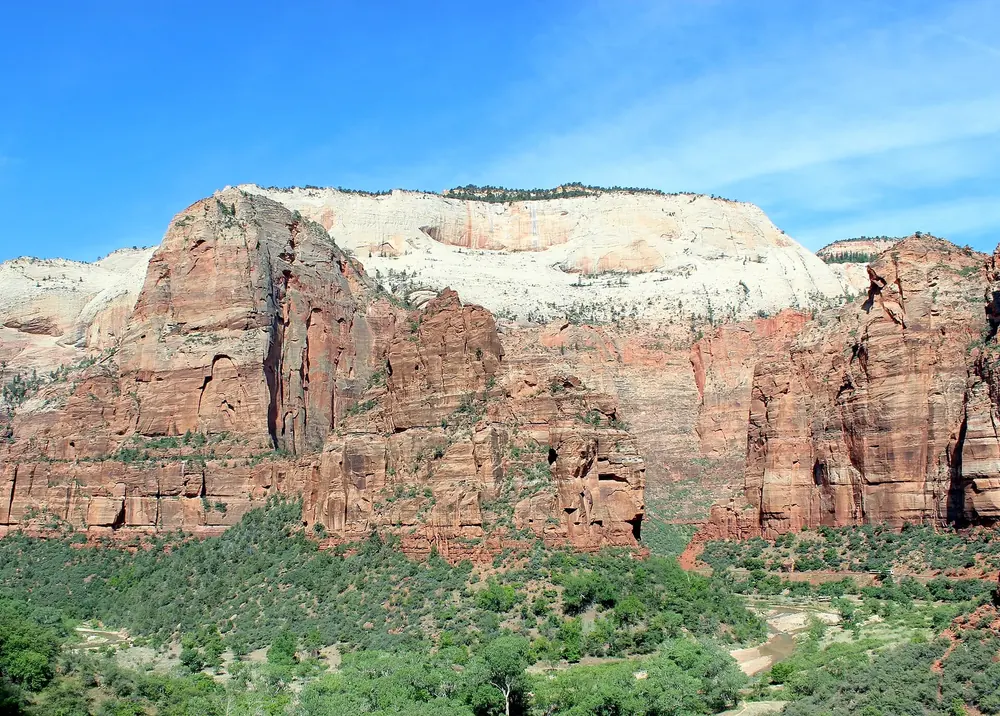Big Bend in Zion National Park: Angels Landing and The Organ, red rock walls above the green canyon floor.