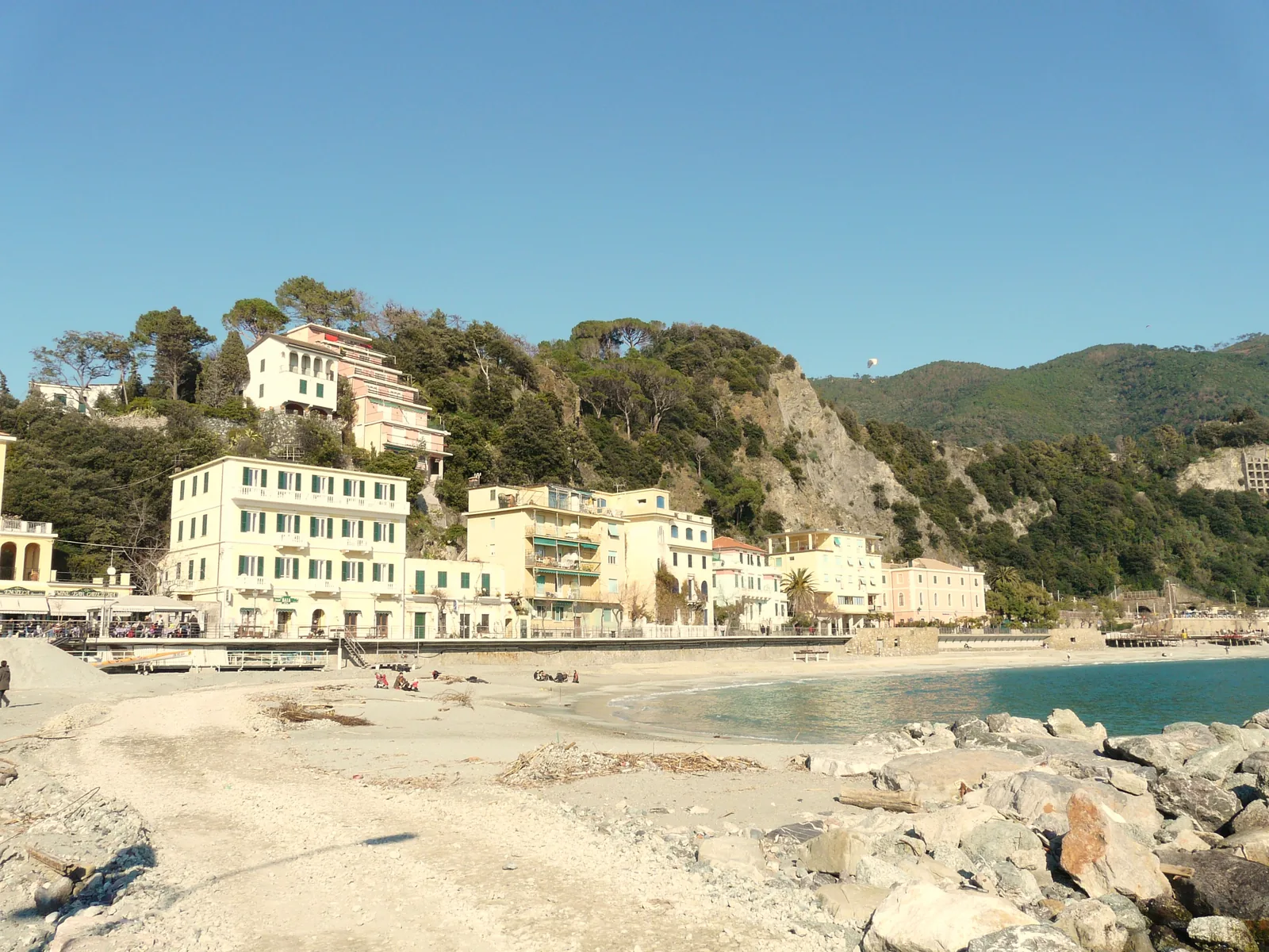 The beach of Fegina in Monterosso al Mare in winter, with hotels on the slope and the Cinque Terre coast behind
