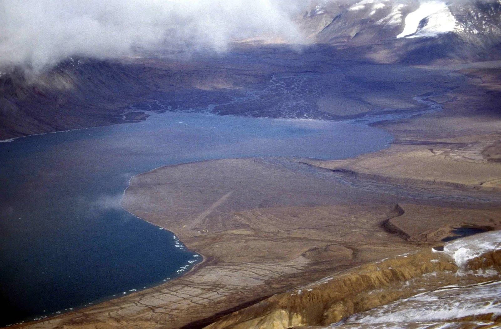 Aerial view of the head of Tanquary Fiord in Quttinirpaaq National Park with the gravel plain where charter flights from Resolute Bay land, bare mountains all around
