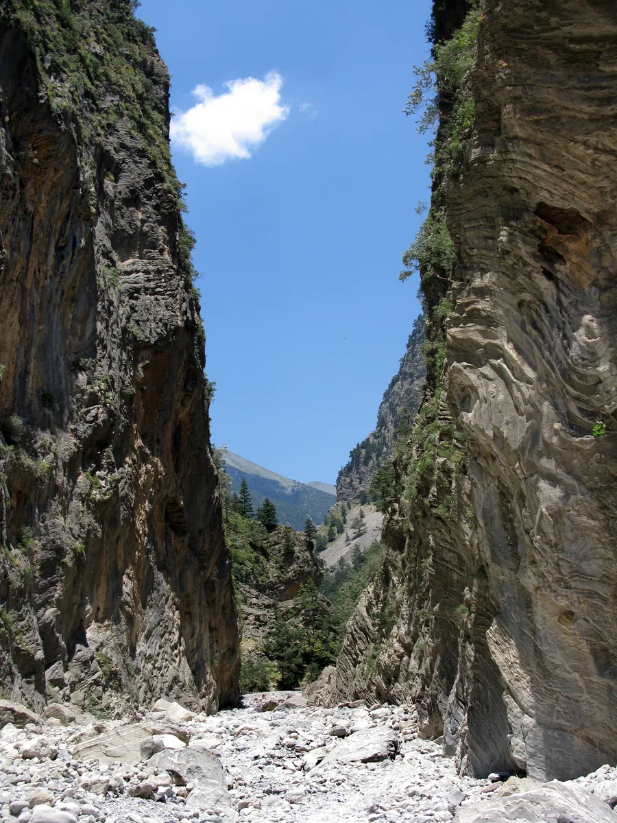 The Portes in the Samaria Gorge: two vertical rock walls stand close together, with a strip of sky and scree between them