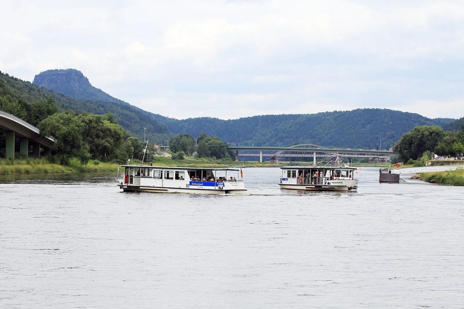 Two white ferry boats on the Elbe at Bad Schandau, wooded slopes and a table mountain behind