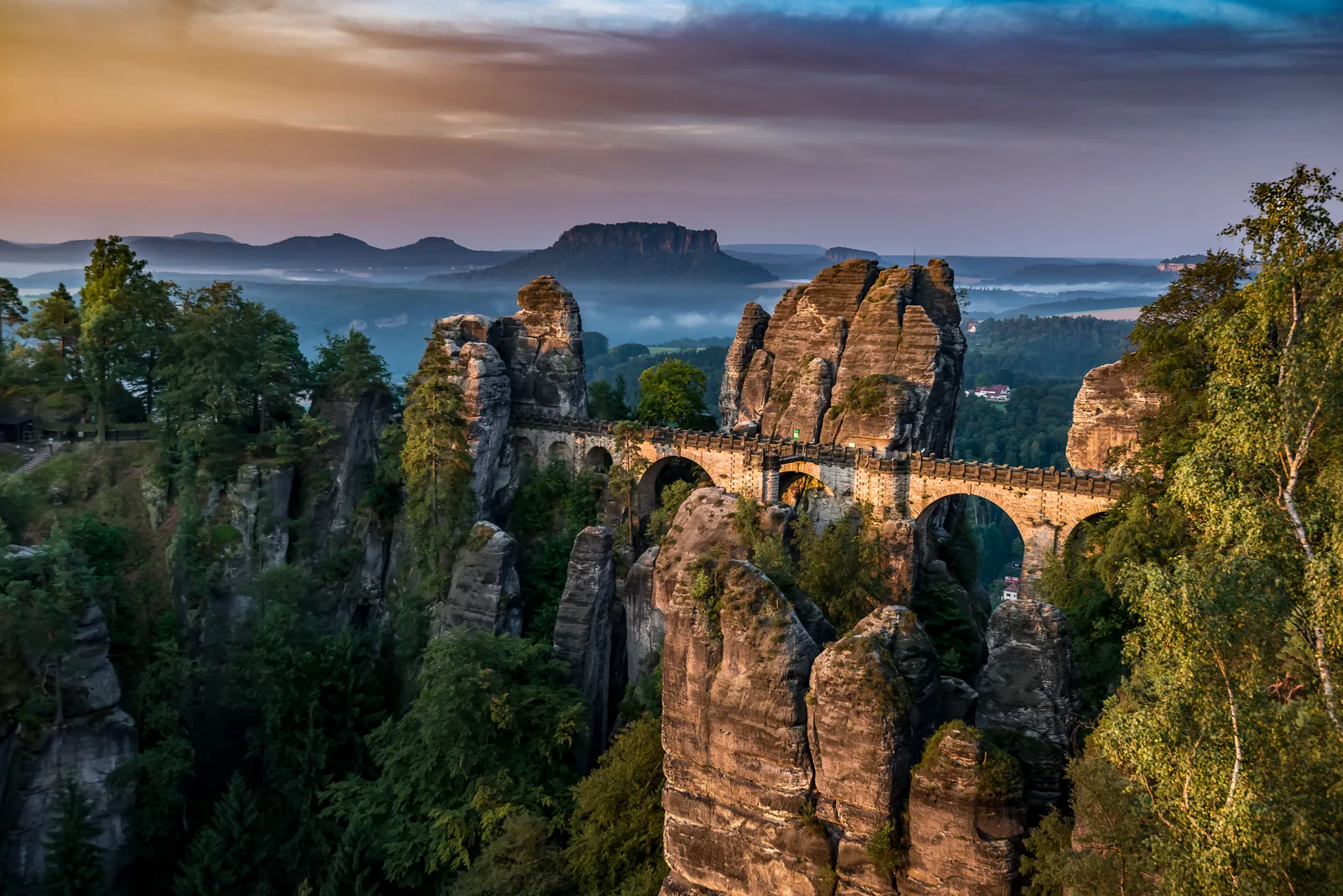 The Bastei Bridge in Saxon Switzerland National Park in evening light above the sandstone towers, the Lilienstein in the haze